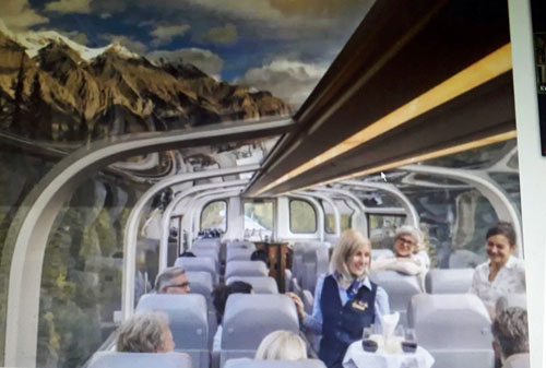 Tourists on a train enjoying the scenery